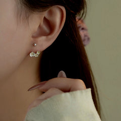 Model showcasing the dangle and style of the Sterling Silver Flower Screw Earrings