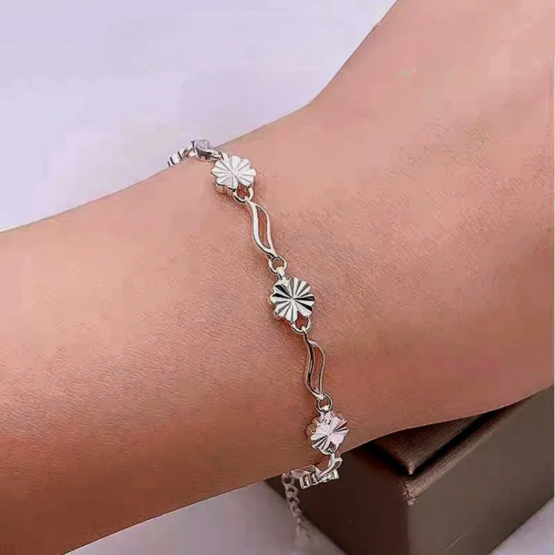 Close-up of the clasp and charm details on the Clover Charm Bracelet