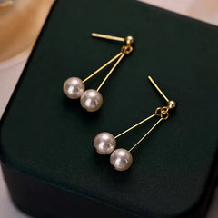 Angled view of the Sterling Silver Hanging Double-Pearl Earrings