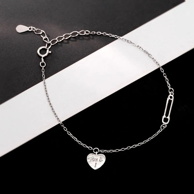 Close-up of the clasp and charm details on the Heart Paper Clip Bracelet
