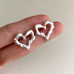 Angled view of the Sterling Silver Heart-Design Stud Earrings