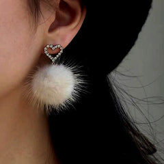 Close-up detail of the sparkling zircons and plating on the Heart Pom Pom Earrings