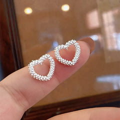 Angled view of the Sterling Silver Heart Stud Earrings