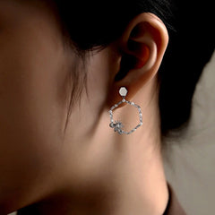 Close-up detail of the sparkling zircons and plating on the Bee Earrings