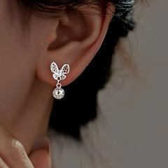 Model showcasing the dangle and style of the Sterling Silver Hollow Butterfly Earrings