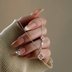 Sterling Silver Hollow Four-Leaf Flower Necklace worn to showcase its length and pendant detail