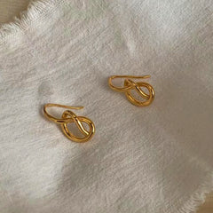 Angled view of the Sterling Silver Hollow Heart-Wrapped Ear Hook Earrings