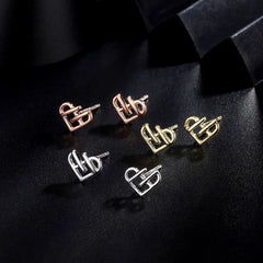 Model showcasing the dangle and style of the Sterling Silver Hollow Heart Stud Earrings
