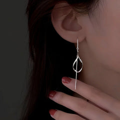 Model showcasing the dangle and style of the Sterling Silver Hollow Wavy Leaf Threader Earrings