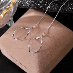 Angled view of the Sterling Silver Hollow Wavy Leaf Threader Earrings