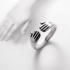 Sterling Silver Hug Palm RIngs worn on the hand to show its beautiful fit and design