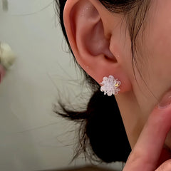 Model showcasing the dangle and style of the Sterling Silver Ice Flower Stud Earrings