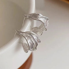 Angled view of the Sterling Silver Irregular Banana Leaf Earrings