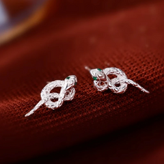 Model showcasing the dangle and style of the Sterling Silver Knot Snake Stud Earrings