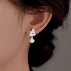 Angled view of the Sterling Silver Leaf Pearl Drop Earrings