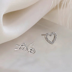 Model showcasing the dangle and style of the Sterling Silver Love Asymmetrical Stud Earrings