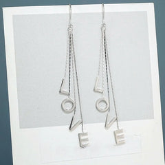 Model showcasing the dangle and style of the Sterling Silver Love Letter Threader Earrings