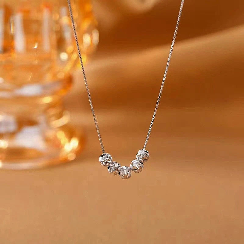 Close-up of the pendant and clasp on the Wreath Heart Necklace