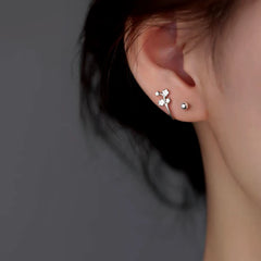 Model showcasing the dangle and style of the Sterling Silver Luxury Peach Blossom Screw Earrings