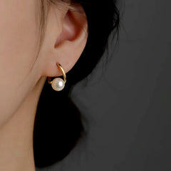 Model showcasing the dangle and style of the Sterling Silver Luxury Pearl Earrings