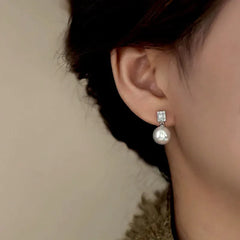 Close-up detail of the sparkling zircons and plating on the Pearl Drop Earrings
