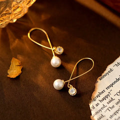 Close-up detail of the sparkling zircons and plating on the Long Pearl Earrings