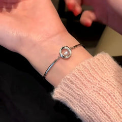 Model wearing the Sterling Silver Mobius Arc-Shaped Smart Bracelet to highlight its design on the wrist