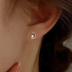 Model showcasing the dangle and style of the Sterling Silver Moon And Star Stud Earrings