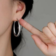Close-up detail of the sparkling zircons and plating on the Oval Hoop Earrings