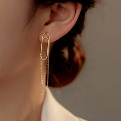 Model showcasing the dangle and style of the Sterling Silver Paper Clip Chain Tassel Earrings