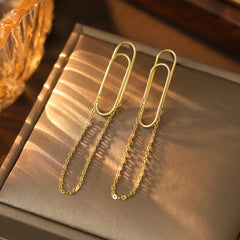 Angled view of the Sterling Silver Paper Clip Chain Tassel Earrings