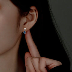 Model showcasing the dangle and style of the Sterling Silver Pearl Blue Flower Earrings