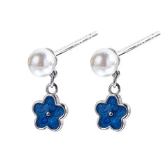 Angled view of the Sterling Silver Pearl Blue Flower Earrings