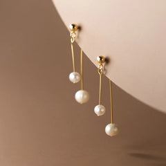 Close-up detail of the sparkling zircons and plating on the Pearl Cross Earrings