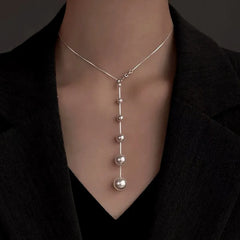 Close-up of the pendant and clasp on the Dainty Pearl Necklace