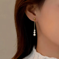 Model showcasing the dangle and style of the Sterling Silver Pearl Tassel Earrings
