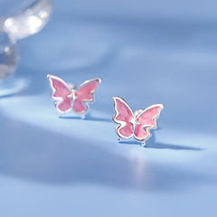 Model showcasing the dangle and style of the Sterling Silver Pink Butterfly Stud Earrings