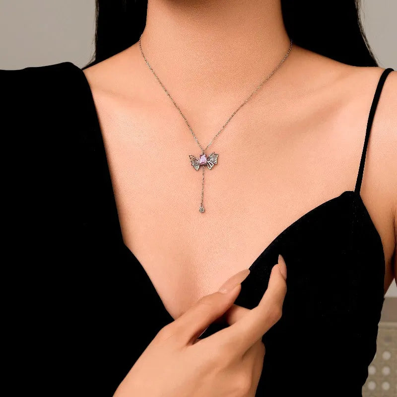 Sterling Silver Pink Diamond Wings Necklace worn to showcase its length and pendant detail