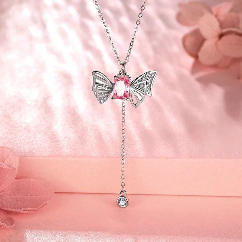 Close-up of the pendant and clasp on the Pink Wings Necklace