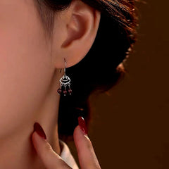 Model showcasing the dangle and style of the Sterling Silver Pomegranate Tassel Ear Hooks