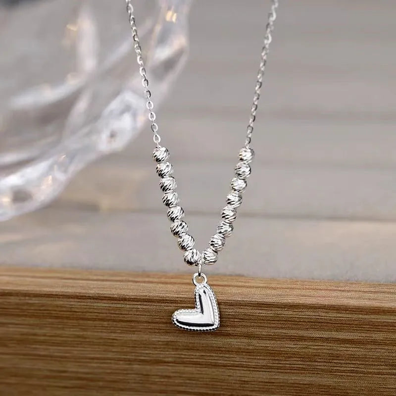 Sterling Silver Round Bead Heart Necklaces worn to showcase its length and pendant detail