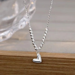 Sterling Silver Round Bead Heart Necklaces worn to showcase its length and pendant detail