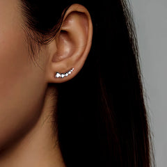 Model showcasing the dangle and style of the Sterling Silver S999 Heart Crawler Earrings
