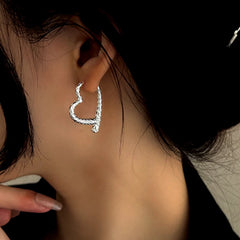 Model showcasing the dangle and style of the Sterling Silver S999 Pure Hanging Heart Earrings