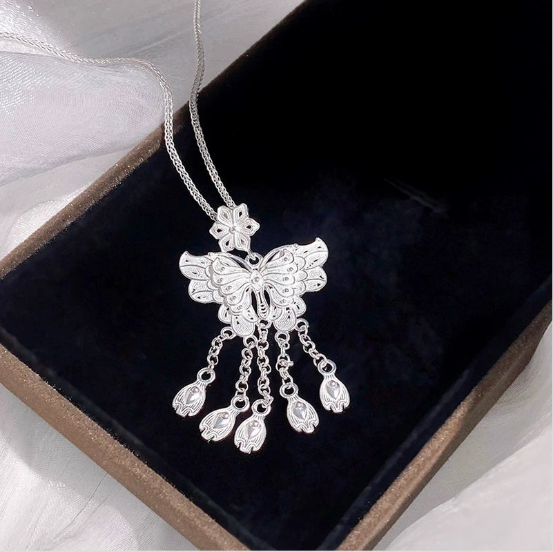 Sterling Silver S999 Sweet Flower Butterfly Tassel Earrings worn to showcase its length and pendant detail