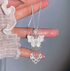 Close-up of the pendant and clasp on the Butterfly Tassel Necklace (*Correction: Handle and original tags imply necklace, not earrings*)