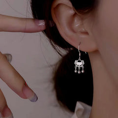 Model showcasing the dangle and style of the Sterling Silver Safety Lock Earrings