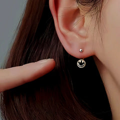 Angled view of the Sterling Silver Screw Smail Face Jacket Earrings