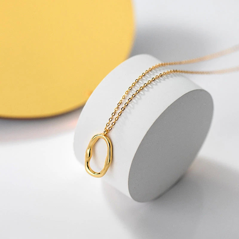 Sterling Silver Simple Geometric Oval Necklace worn to showcase its length and pendant detail