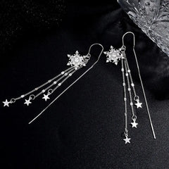 Model showcasing the dangle and style of the Sterling Silver Snowflake Star Threader Tassel Earrings